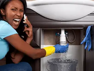 Emergency plumbing repair for a leaking sink drain under a bathroom vanity in Virginia Beach, VA