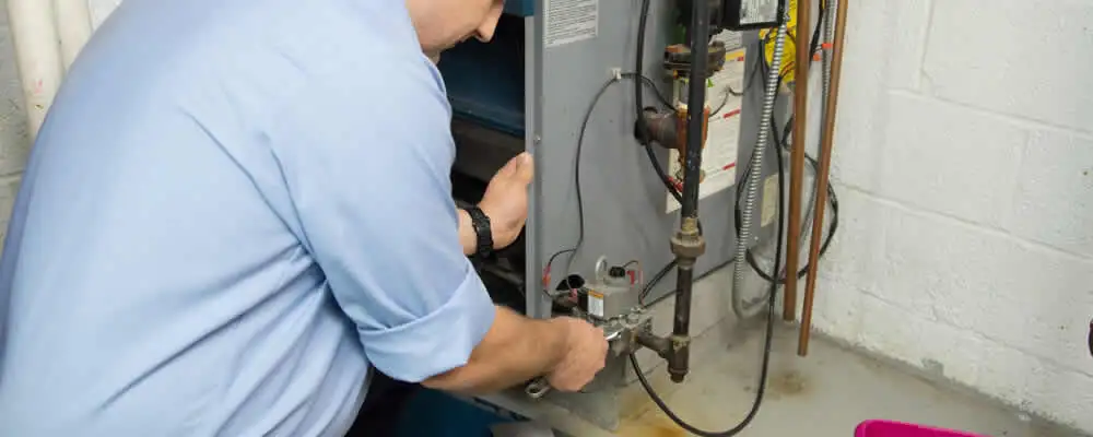 Furnace repair technician inspecting and servicing a home heating system in Virginia Beach, VA