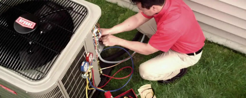 HVAC technician servicing an outdoor air conditioner unit in Virginia Beach, VA
