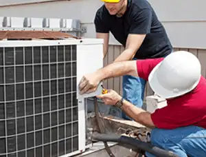 HVAC technicians repairing an outdoor AC unit on a rooftop in Virginia Beach, VA